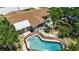 Aerial shot of the home's kidney-shaped pool with an intricate stone design and pool fence at 5705 9Th Ave Dr W, Bradenton, FL 34209