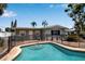 Backyard pool featuring brick pavers, mature trees, privacy fence and attached home at 5705 9Th Ave Dr W, Bradenton, FL 34209