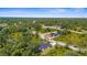 Aerial view of homes surrounded by mature trees and lush landscaping in a beautiful neighborhood at 5945 Nyberg Rd, North Port, FL 34286