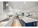 Bright, open kitchen featuring stainless steel appliances, gas range, subway tile backsplash and large center island at 6152 Lungo Lago Dr, Sarasota, FL 34241
