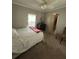 Bedroom with a ceiling fan, natural light, and a dark dresser at 6357 Partridge Ave, Englewood, FL 34224