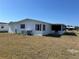 Single-story home featuring white siding, black shutters, an enclosed porch, and well-kept landscaping at 6357 Partridge Ave, Englewood, FL 34224