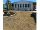 Well-maintained front yard showcasing lush landscaping and curb appeal with meticulous rock placement at 6357 Partridge Ave, Englewood, FL 34224