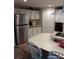Spacious kitchen featuring modern appliances, white cabinets, an island, and an electric cooktop at 6357 Partridge Ave, Englewood, FL 34224
