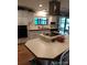 Bright kitchen features white cabinets and an island cooktop at 6357 Partridge Ave, Englewood, FL 34224
