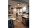Well-equipped kitchen featuring white cabinetry, lots of counter space, and modern appliances and wood laminate at 6357 Partridge Ave, Englewood, FL 34224