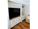 Cozy living room featuring built-in shelving, comfortable seating, and stylish decor with wood laminate flooring at 6357 Partridge Ave, Englewood, FL 34224