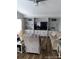 Cozy living room with built-in shelving, recessed lighting, and comfortable seating area and wood laminate flooring at 6357 Partridge Ave, Englewood, FL 34224