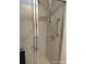 A walk-in shower stall with adjustable shower head and grab bar at 6357 Partridge Ave, Englewood, FL 34224