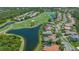 Aerial view of stunning home features backyard pool, lake view, and golf course at 6633 The Masters Ave, Lakewood Ranch, FL 34202