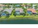 Aerial view of home features backyard pool, lush landscaping, and beautiful lake view at 6633 The Masters Ave, Lakewood Ranch, FL 34202