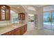 Wet bar area features wood cabinetry, a marble countertop, and mirrored backsplash near the pool area at 6633 The Masters Ave, Lakewood Ranch, FL 34202