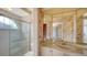 This bathroom features a glass shower and a vanity with decorative wallpaper at 6633 The Masters Ave, Lakewood Ranch, FL 34202
