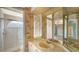 This bathroom features a glass shower and a vanity with decorative wallpaper at 6633 The Masters Ave, Lakewood Ranch, FL 34202