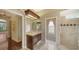 A well-lit bathroom features a vanity, shower, and decorative wallpaper at 6633 The Masters Ave, Lakewood Ranch, FL 34202