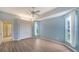 This bedroom features light blue paint, wood-look floors, windows with natural light, and a closet at 6633 The Masters Ave, Lakewood Ranch, FL 34202
