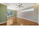 A spacious bedroom features hardwood floors, a window with a view and plenty of sunlight at 6633 The Masters Ave, Lakewood Ranch, FL 34202