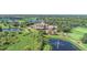 Beautiful aerial view of community clubhouse overlooks lush landscaping, ponds, and golf course at 6633 The Masters Ave, Lakewood Ranch, FL 34202