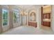 Bright dining room with lots of natural light and a decorative chandelier with columns for design at 6633 The Masters Ave, Lakewood Ranch, FL 34202