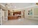 Spacious kitchen with tile flooring, wood cabinets, and an expansive island that is perfect for entertaining at 6633 The Masters Ave, Lakewood Ranch, FL 34202