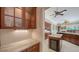 A view of the kitchen with an island, wine storage, and wooden cabinets at 6633 The Masters Ave, Lakewood Ranch, FL 34202