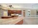 Bright kitchen with a large marble counter, wooden cabinets, and modern appliances for a seamless cooking experience at 6633 The Masters Ave, Lakewood Ranch, FL 34202