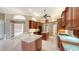 Gourmet kitchen featuring wood cabinetry, a central island, and an open layout perfect for gatherings at 6633 The Masters Ave, Lakewood Ranch, FL 34202
