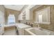 This laundry room has a large window, sink, and cabinet space at 6633 The Masters Ave, Lakewood Ranch, FL 34202