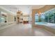 Comfortable open-concept living room with a fireplace and views of the pool and backyard at 6633 The Masters Ave, Lakewood Ranch, FL 34202