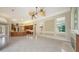 Open-concept living space featuring tile floors, a fireplace, and a seamless flow to the kitchen area at 6633 The Masters Ave, Lakewood Ranch, FL 34202