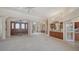 Bright open-concept living room with arched windows, columns, and a built-in wet bar for entertaining at 6633 The Masters Ave, Lakewood Ranch, FL 34202