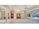 Spacious living room with an open floor plan, columns, and sliding glass doors to the pool area at 6633 The Masters Ave, Lakewood Ranch, FL 34202