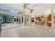Bright living room offering an indoor-outdoor flow to the pool, with tile flooring, and neutral decor at 6633 The Masters Ave, Lakewood Ranch, FL 34202