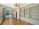 Spacious living room with built-in bookshelves, hardwood floors, and sliding doors to the pool at 6633 The Masters Ave, Lakewood Ranch, FL 34202