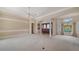 Open-concept living room featuring a large front door and arched windows allowing for plenty of natural light at 6633 The Masters Ave, Lakewood Ranch, FL 34202
