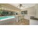 Well-equipped outdoor kitchen and bar area with a clear view of the pool and lush backyard at 6633 The Masters Ave, Lakewood Ranch, FL 34202