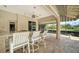Outdoor kitchen and bar area with seating; perfect for entertaining with lake views at 6633 The Masters Ave, Lakewood Ranch, FL 34202