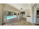 Covered outdoor kitchen area overlooking the pool, complete with bar seating and a sink at 6633 The Masters Ave, Lakewood Ranch, FL 34202