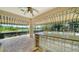 Inviting outdoor kitchen with bar seating, offering scenic views of the lake and pool at 6633 The Masters Ave, Lakewood Ranch, FL 34202
