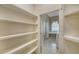 Walk-in pantry features spacious shelving for optimal storage and organization at 6633 The Masters Ave, Lakewood Ranch, FL 34202