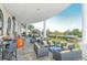 Elegant outdoor patio featuring stylish seating, stone flooring, and scenic views of the lush landscape at 6633 The Masters Ave, Lakewood Ranch, FL 34202