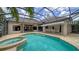 Refreshing screened pool and spa area with an outdoor kitchen, perfect for relaxation at 6633 The Masters Ave, Lakewood Ranch, FL 34202