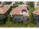 Aerial view of a backyard pool, screened-in lanai, and solar panels at 6951 Scrub Jay Dr, Sarasota, FL 34241