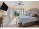 Bright bedroom showcasing tray ceilings, a large bay window, and elegant furnishings at 6951 Scrub Jay Dr, Sarasota, FL 34241