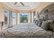 A bedroom with tray ceilings, large window with shutters, and attractive color schemes at 6951 Scrub Jay Dr, Sarasota, FL 34241