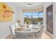Sunny dining area features backyard views, modern light fixture, and seating for six at 6951 Scrub Jay Dr, Sarasota, FL 34241
