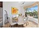 Sunny dining area features backyard views, modern light fixture, and seating for six at 6951 Scrub Jay Dr, Sarasota, FL 34241