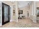 Inviting foyer with tile flooring, decorative chandelier, and elegant columns leading to the dining area at 6951 Scrub Jay Dr, Sarasota, FL 34241