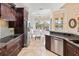Well-appointed kitchen featuring granite countertops, stainless steel appliances, and a breakfast nook with lake views at 6951 Scrub Jay Dr, Sarasota, FL 34241