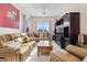 Inviting living room featuring matching couches, entertainment center, and window views at 6951 Scrub Jay Dr, Sarasota, FL 34241